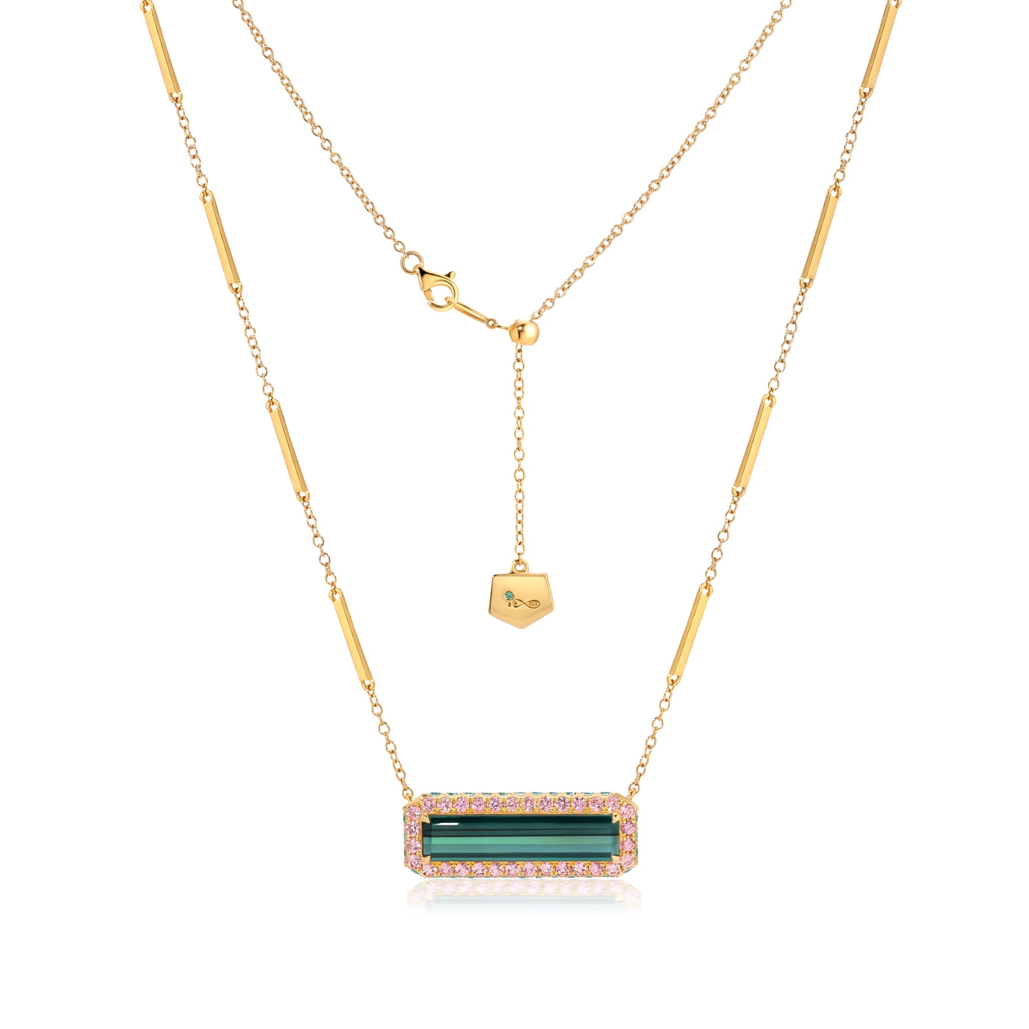 An 18K gold necklace with an indicolite tourmaline amulet pendant, surrounded by pink sapphire accents, and additional gold chains.
