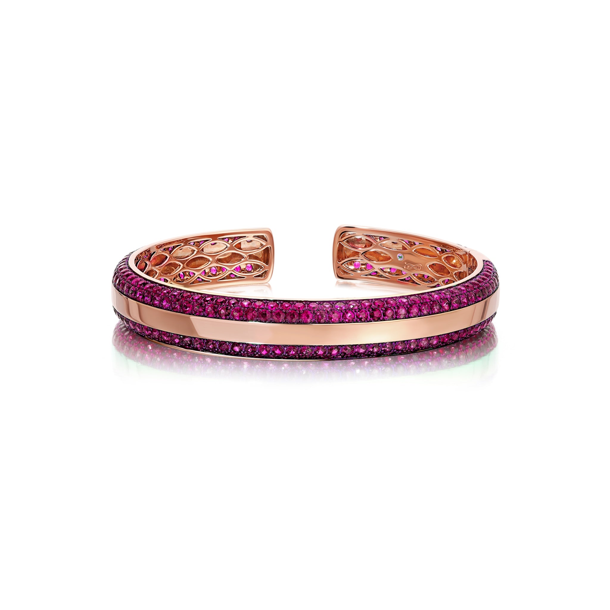 Three-sided pink sapphire bangle with a golden band and pink sapphires set in vivid cranberry rhodium